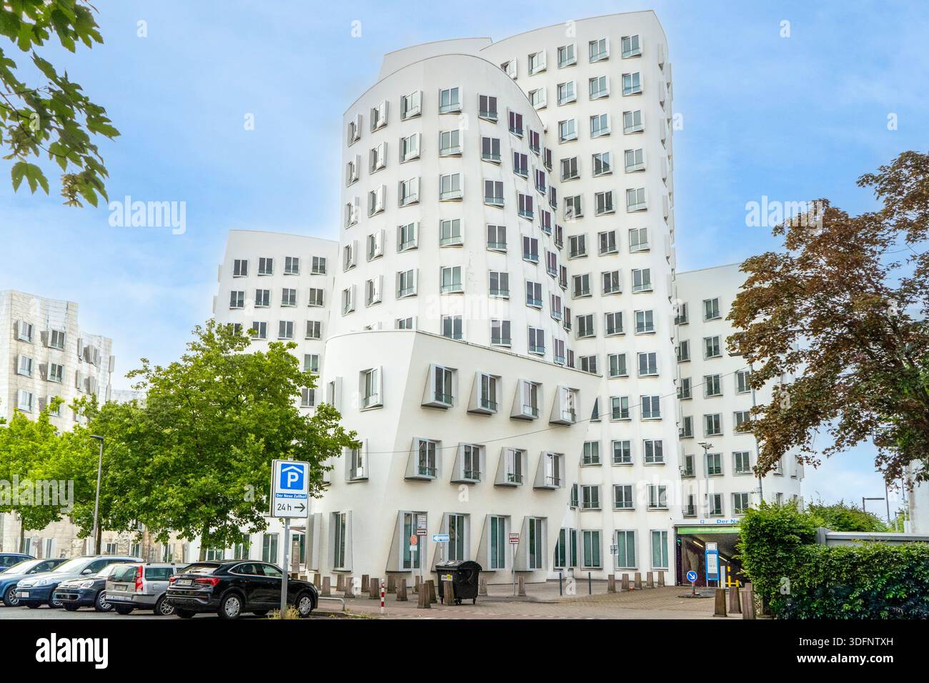 Modern architectural masterpiece of the white Gehry Bauten tower under a clear sky in Düsseldorf Germany Stock Photo