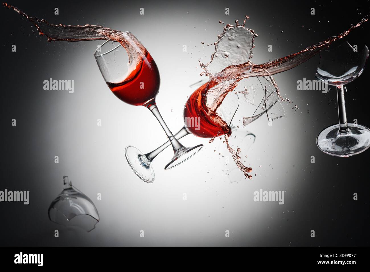 Shattered Red Wine Glasses with Splattering Drops and Fragments Stock Photo  - Alamy