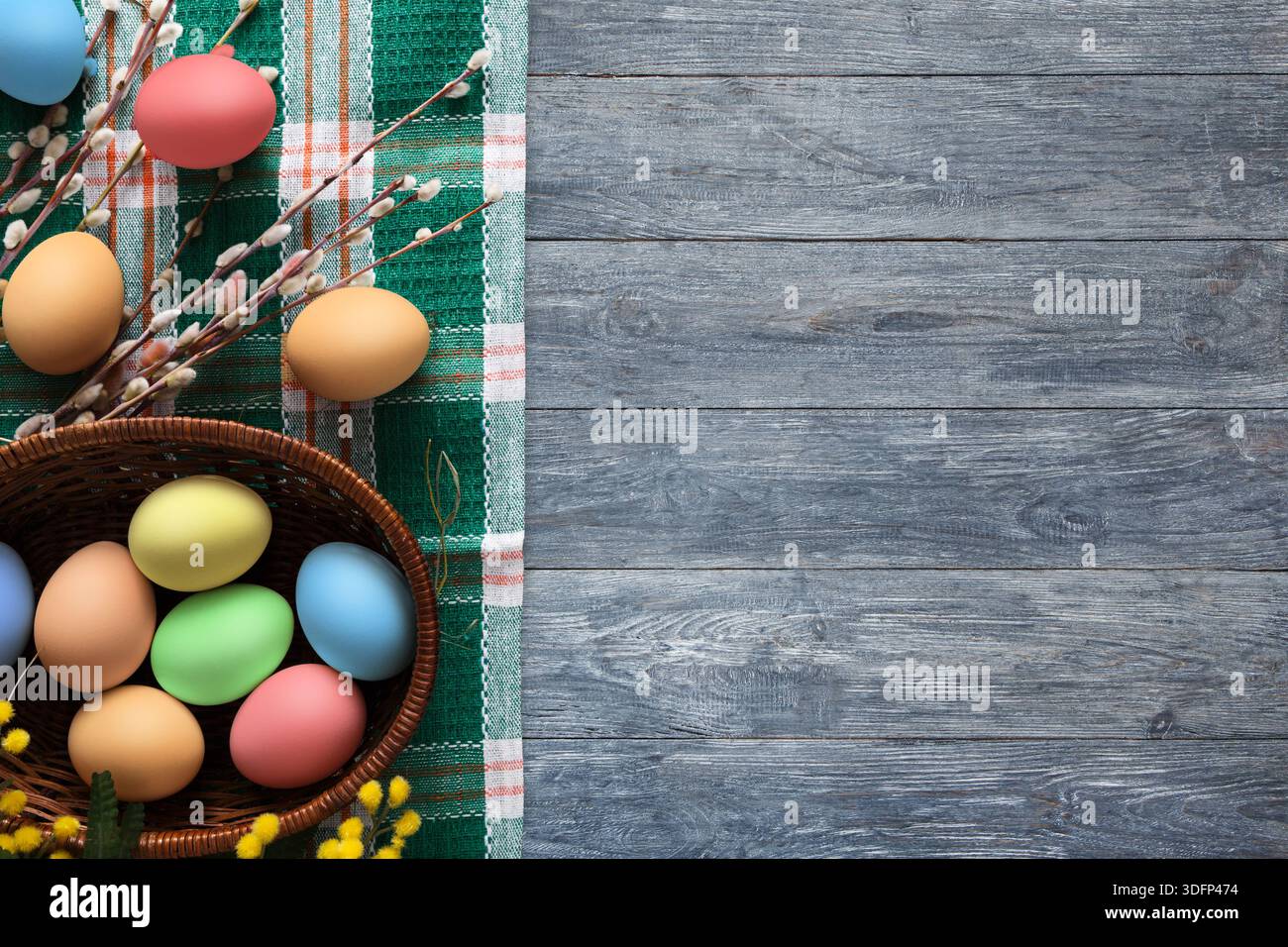 Colorful Eggs Arranged With Decorative Elements on a Rustic Wooden Table Setting Stock Photo
