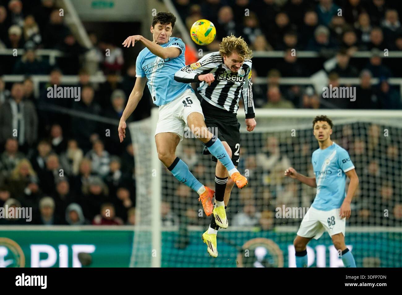 Manchester City's Abdukodir Khusanov, left, jumps for the ball