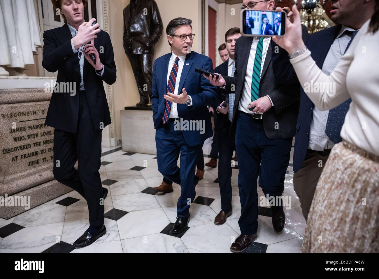 House Speaker Mike Johnson (R-La.) speaks with reporters as he walks to ...