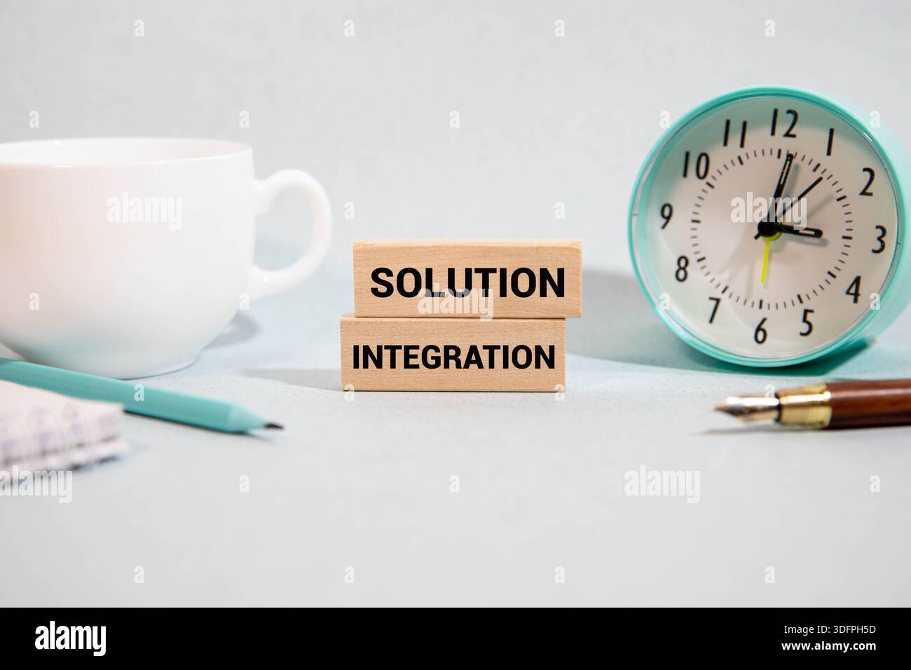 Concept of solution integration write on sticky notes isolated on Wooden Table. Stock Photo