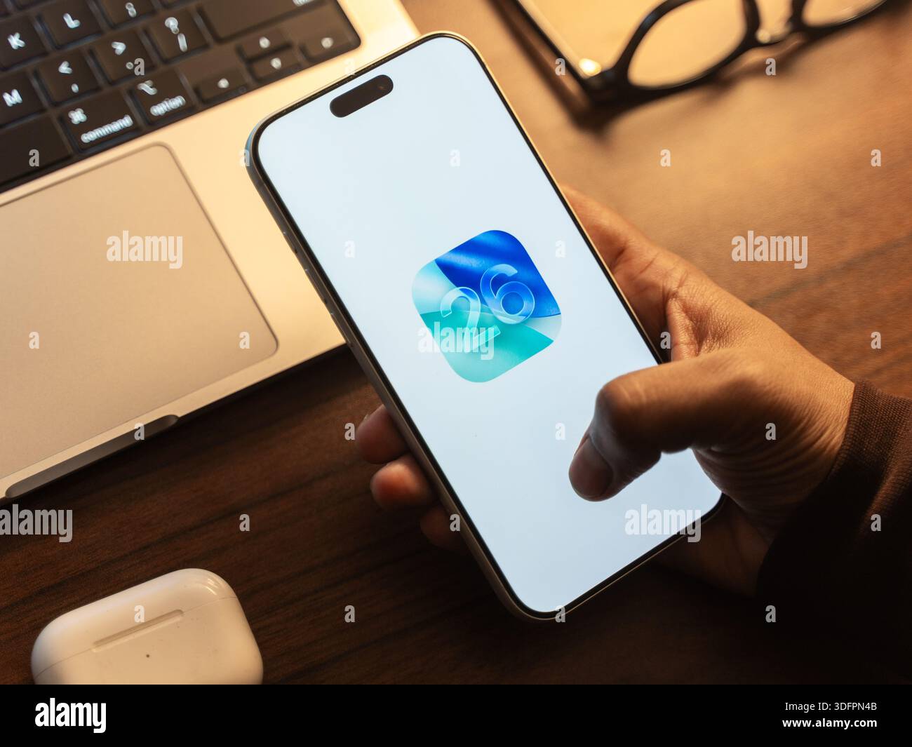 IOS 26 logo is displayed on the screen of a smartphone, in Bangalore, India, on January 14, 2026 Stock Photo