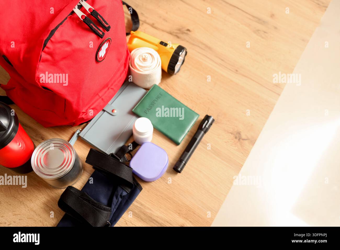 Emergency backpack with necessities on desk in classroom, top view Stock Photo