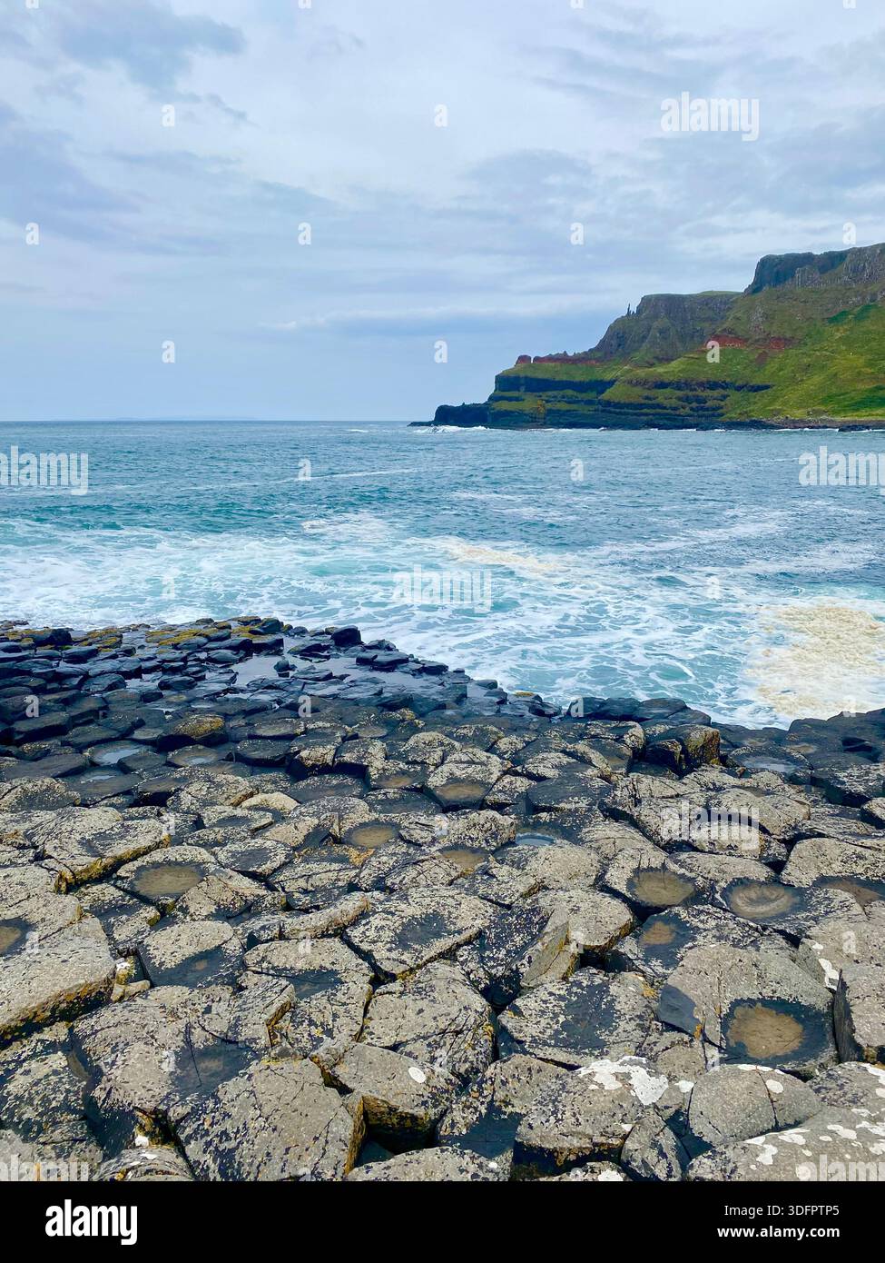 Hexagonal basalt rock formations at the Giant’s Causeway along the North Atlantic coast, Northern Ireland. - Smartphone Captured Stock Image