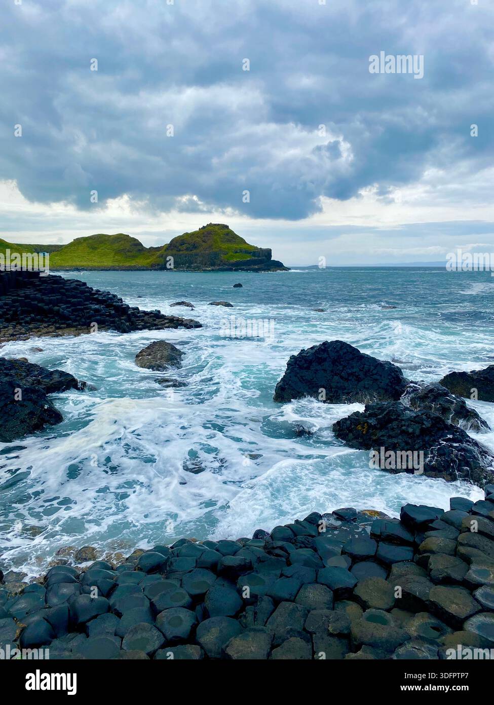 Hexagonal basalt rock formations at the Giant’s Causeway along the North Atlantic coast, Northern Ireland. - Smartphone Captured Stock Image