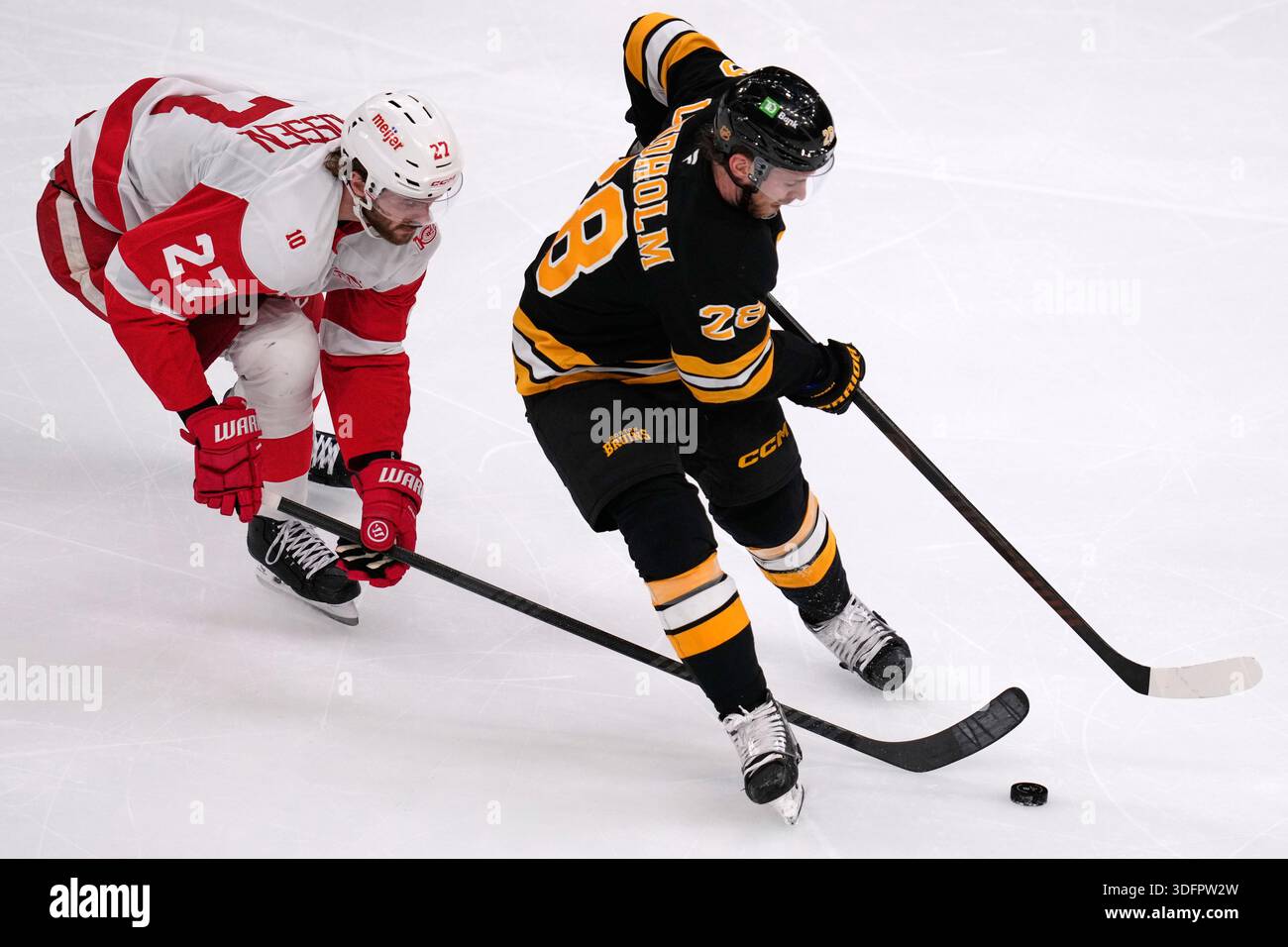 Detroit Red Wings center Michael Rasmussen (27) tries to steal the puck ...
