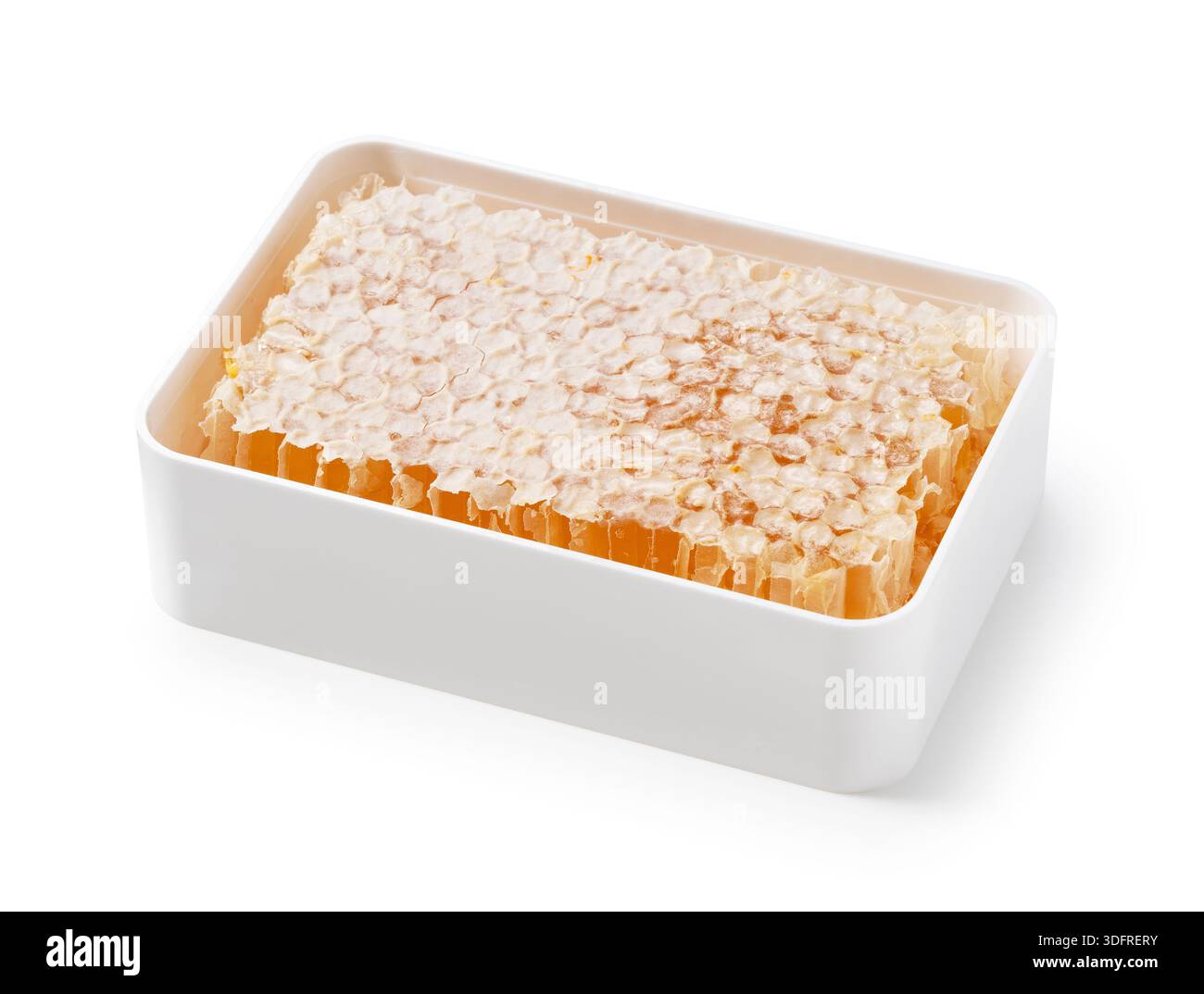 Fresh Organic Honeycomb Slab in a White Plastic Container Isolated on White Background Stock Photo