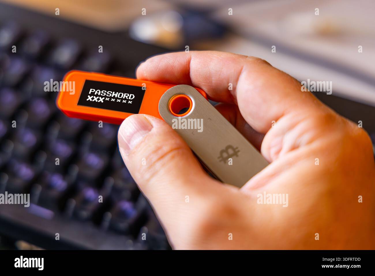 hardware Bitcoin wallet held in white hand with password message on screen  Stock Photo - Alamy