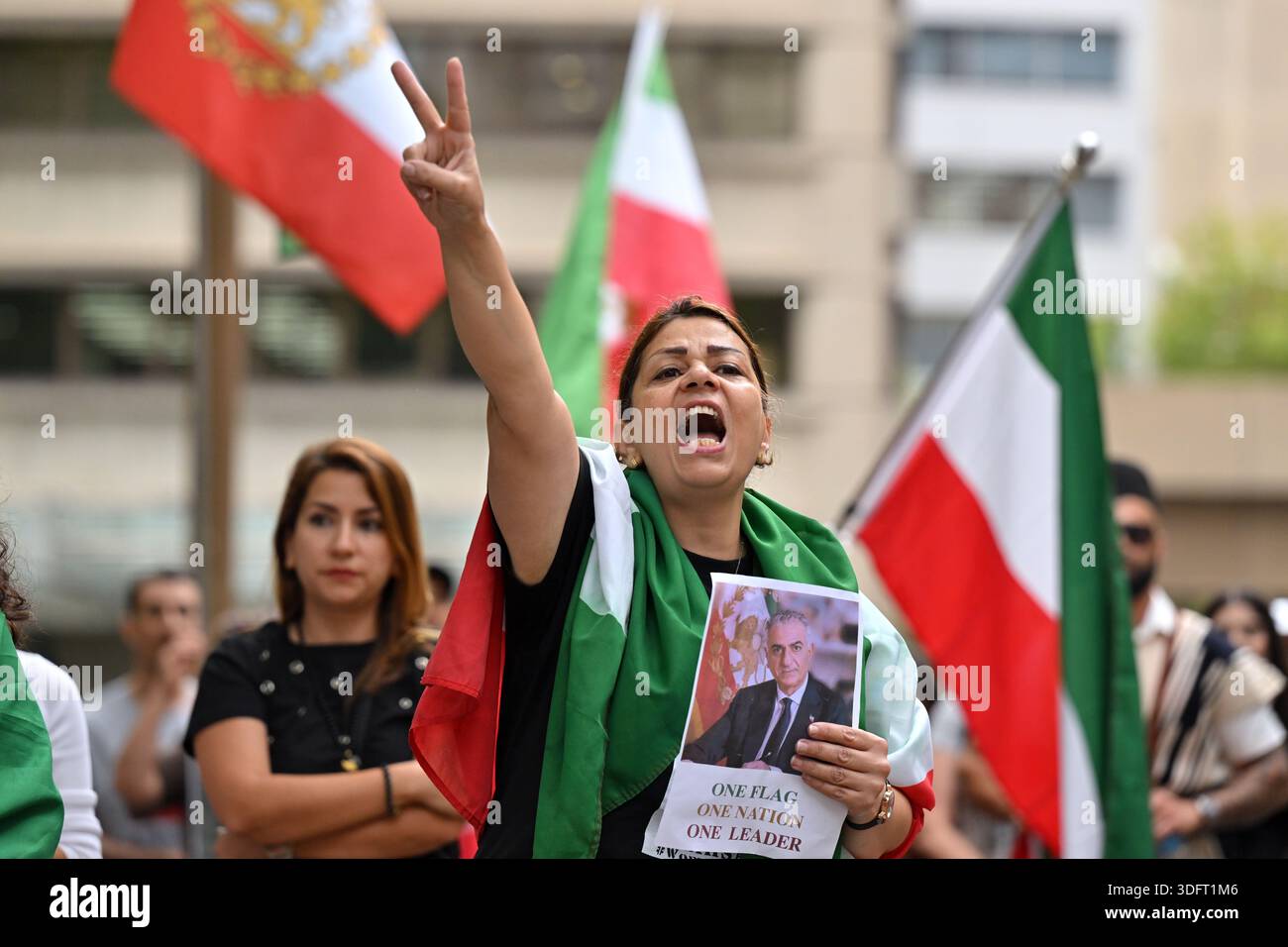 Protesters with flags and banners are seen at a rally in solidarity ...