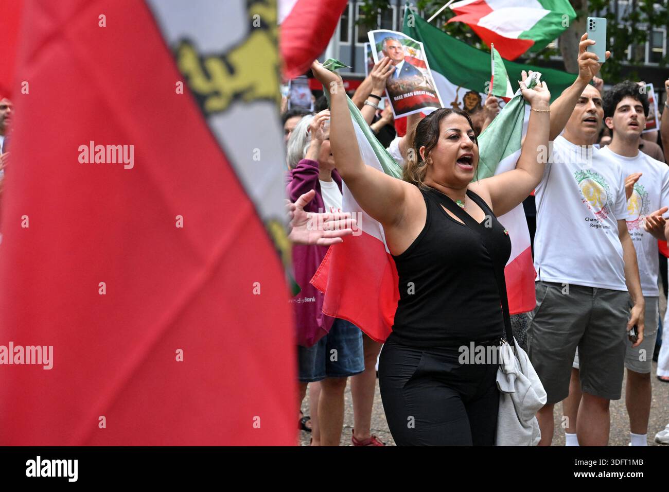 Protesters with flags and banners are seen at a rally in solidarity ...