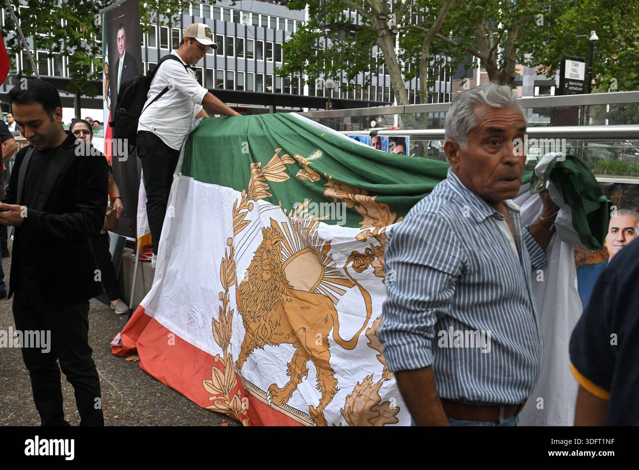 Protesters with flags and banners are seen at a rally in solidarity ...