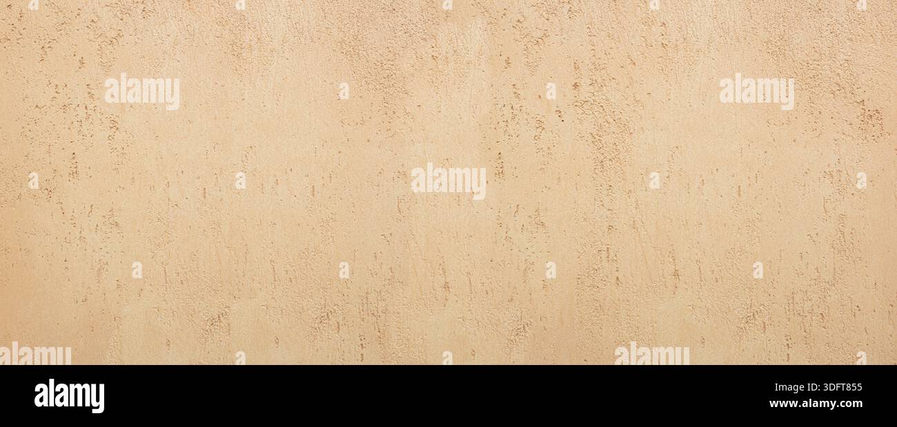 Beige plaster wall showing a rough and abstract textured surface Stock Photo