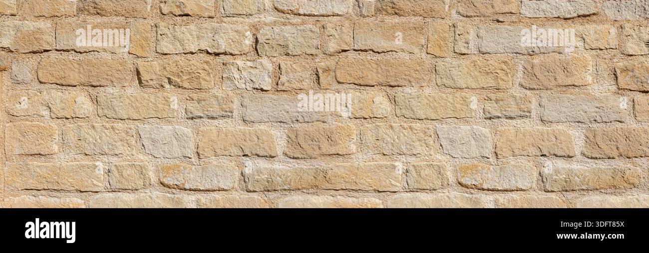 Sandstone wall surface with beige blocks and visible mortar joints Stock Photo