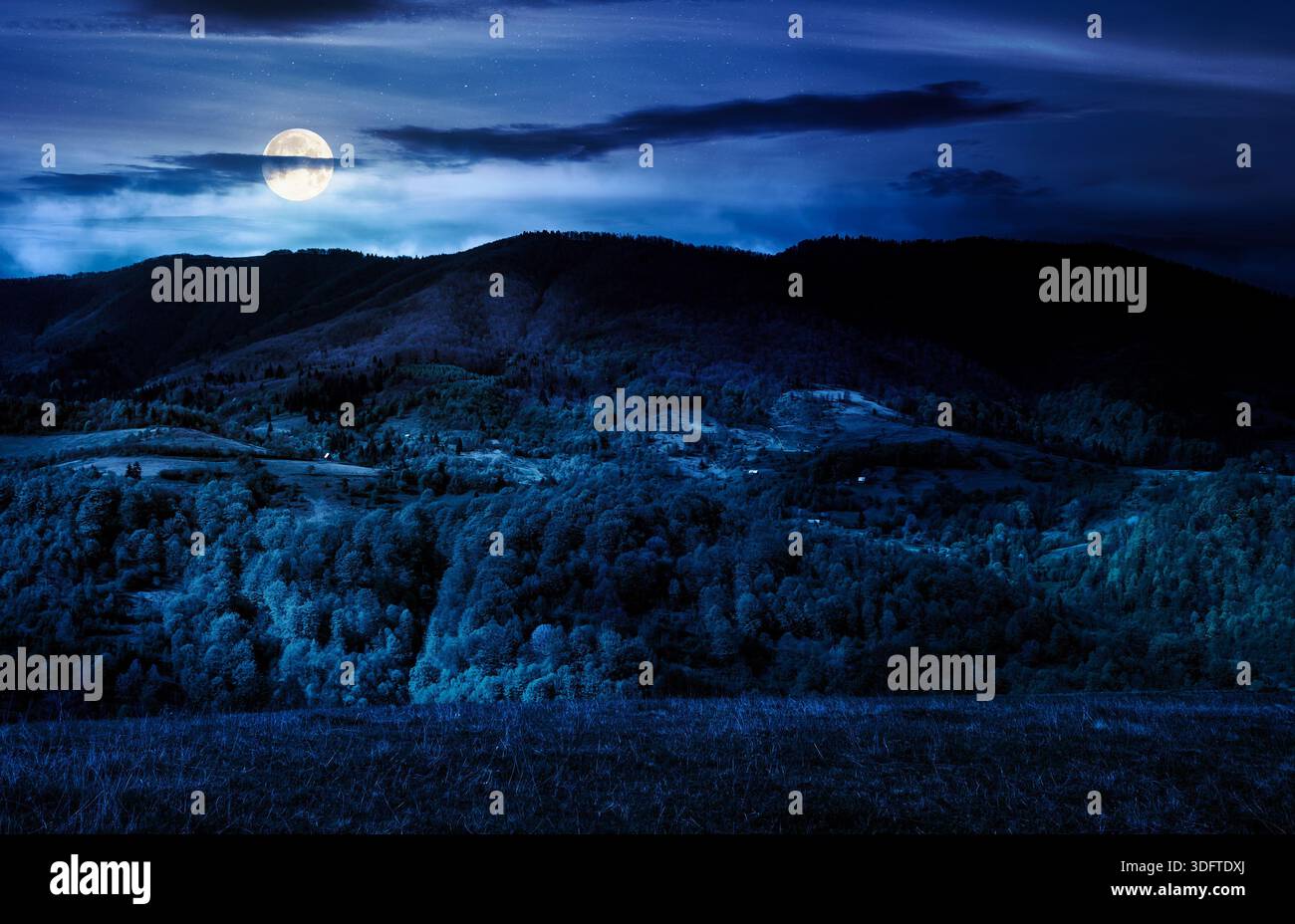 forested mountain slopes in springtime. lovely countryside landscape. mountainous rural area under the cloudy sky Stock Photo