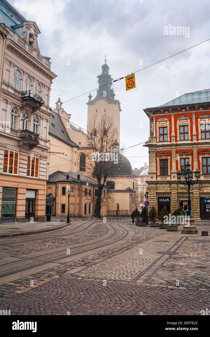 lviv, ukraine - 17 nov 2012: view of lviv city architecture on a misty morning. concept scene of old town with cobblestone street. background for trav Stock Photo