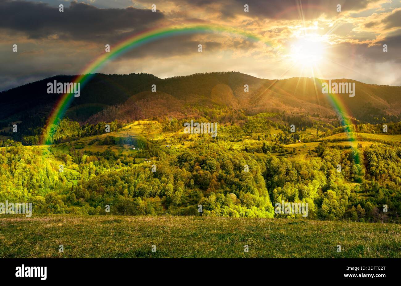 forested mountain slopes in springtime. lovely countryside landscape. mountainous rural area under the cloudy sky Stock Photo