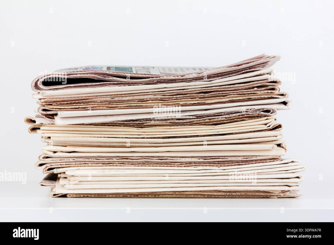 a large stack of newspapers on the table Stock Photo