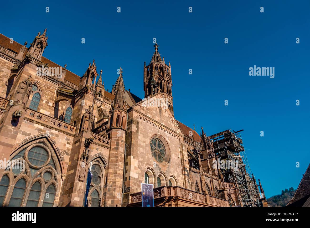 Low-angle view of Freiburg Cathedral (Muenster - Minster) in Freiburg, Germany - Stock Image
