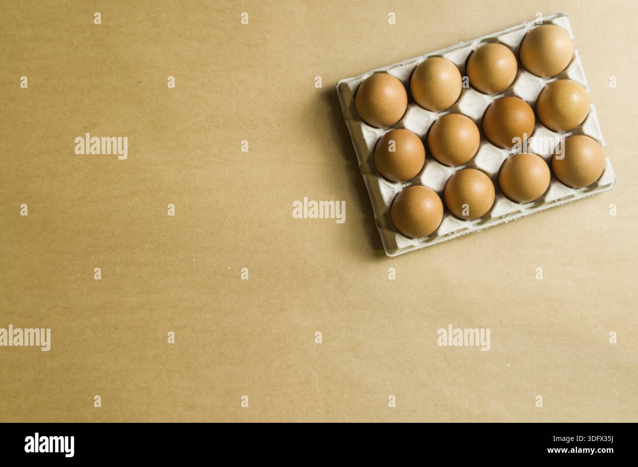 Beautiful fresh brown chicken eggs on brown background with copy space Stock Photo