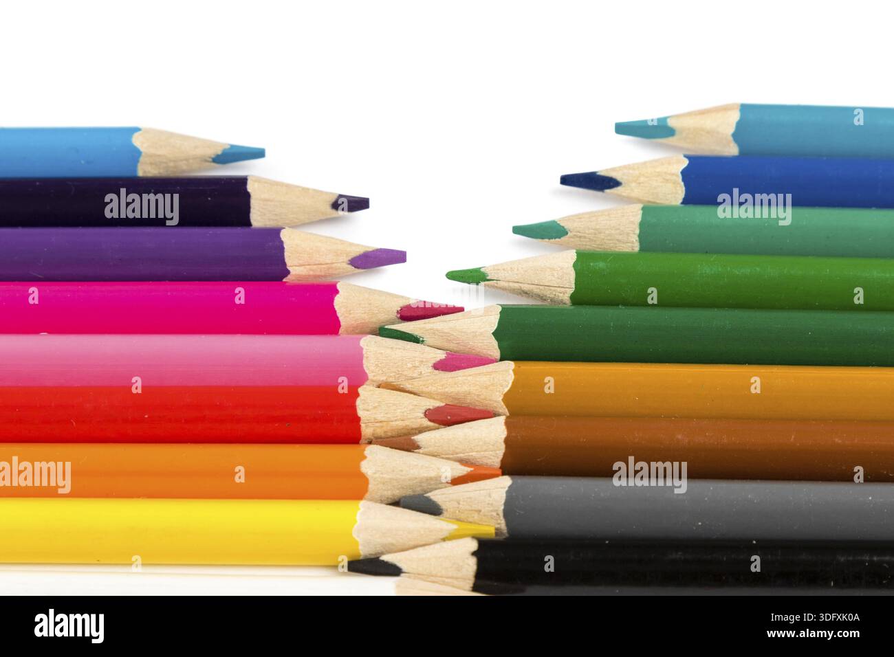 Color pencils on white table with tips in zigzag composition Stock Photo