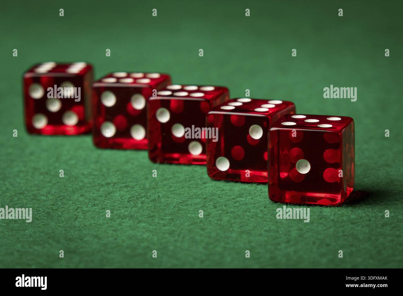 Five red casino dices on a green table Stock Photo