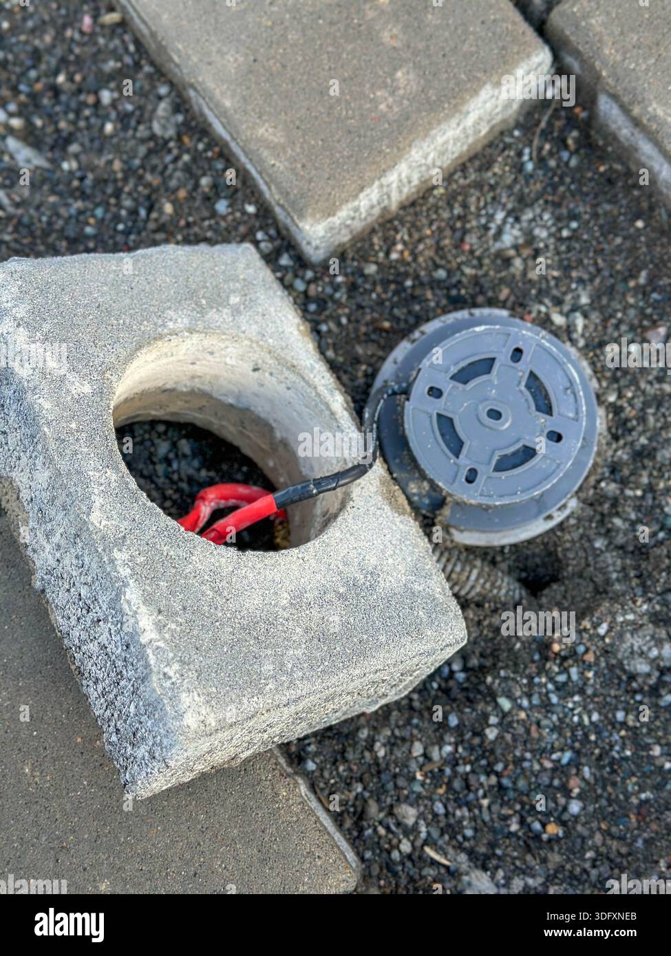 Pave Wire Sidewalk lighting installation with exposed wiring and paving blocks ...