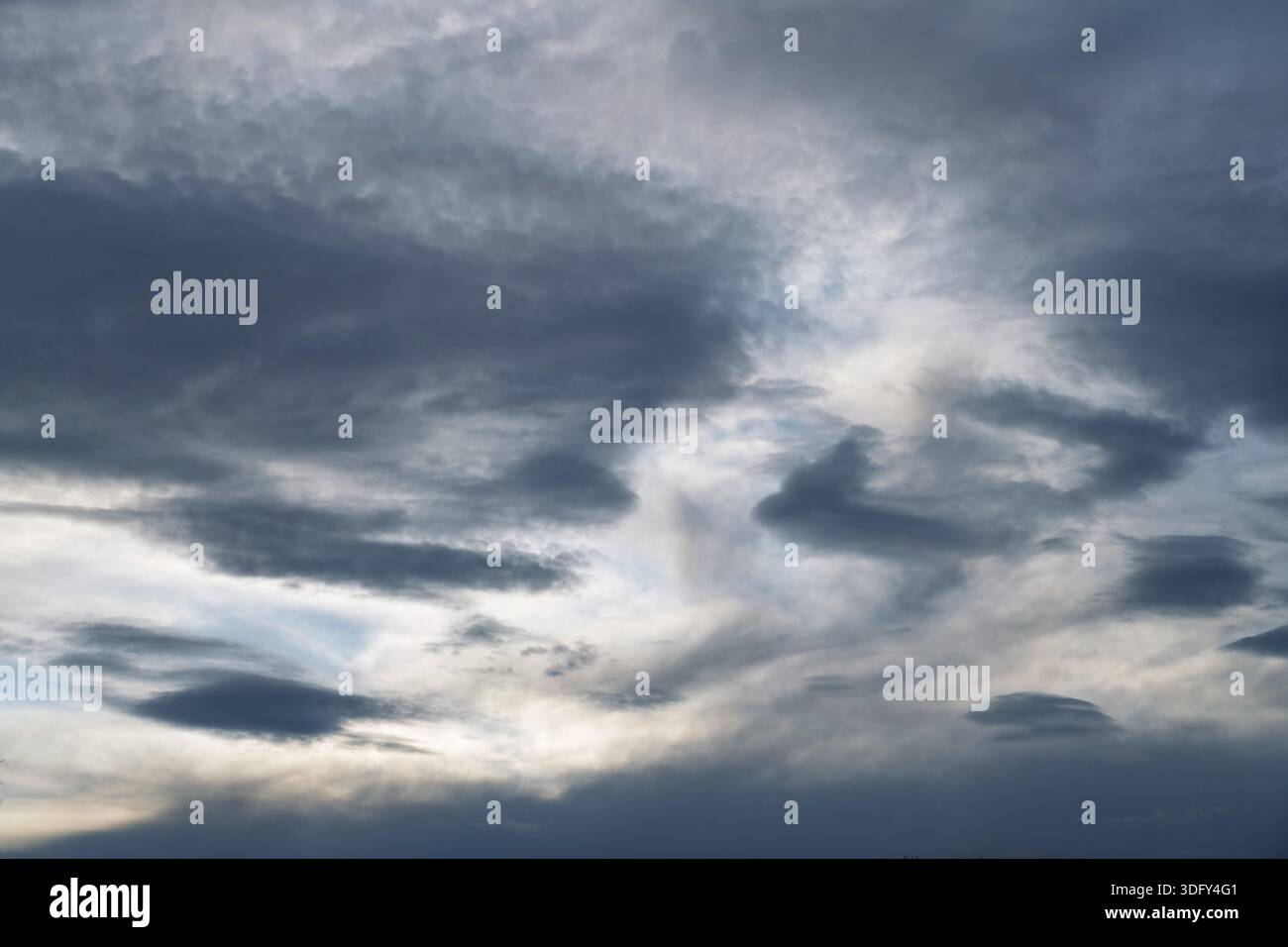 A threatening grey cloudy evening sky. Stock Photo