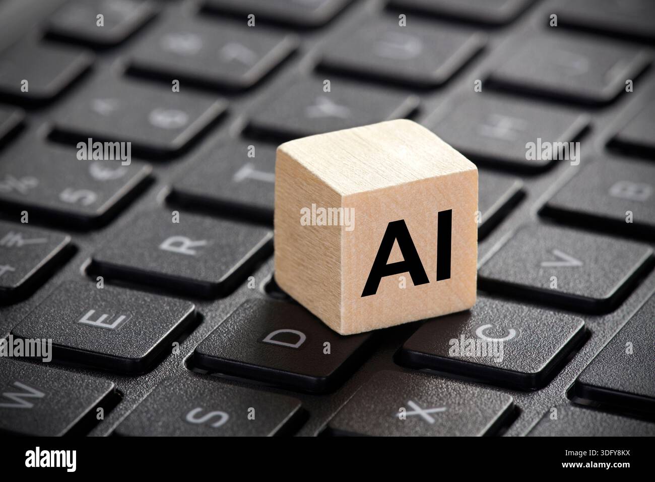 Wooden block with artificial intelligence symbol on computer keyboard Stock Photo