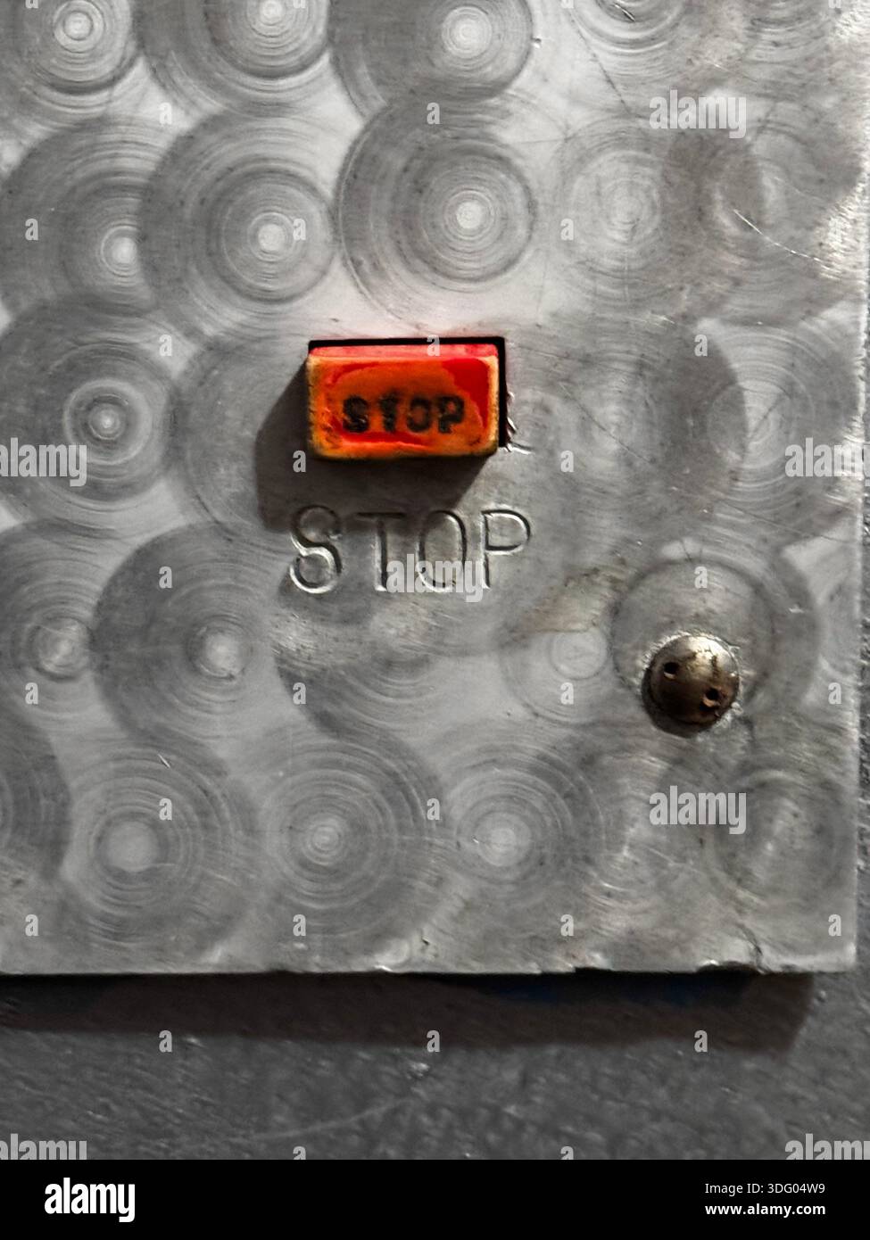 Industrial Stop Button on Metal Panel for Safety Applications Stock Photo