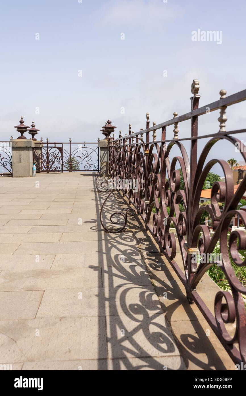 Viewpoint Railing Wrought iron railing on top of Masonic Mausoleum, decorative shadows ...