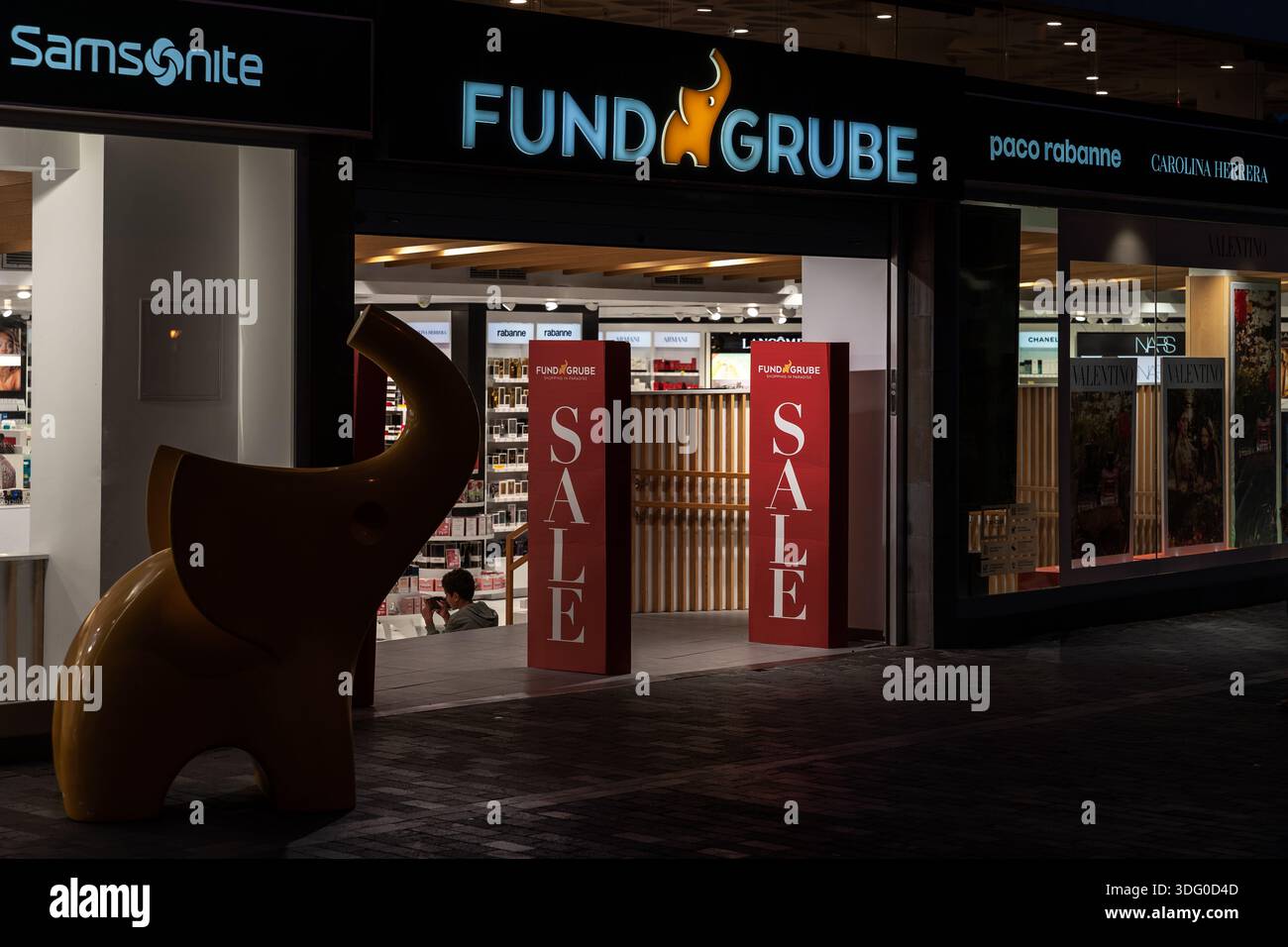 PUERTO DE LA CRUZ, TENERIFE, SPAIN - AUGUST 9, 2025: Fund Grube store entrance with sale signs and brand logos at shopping area in evening. Stock Photo