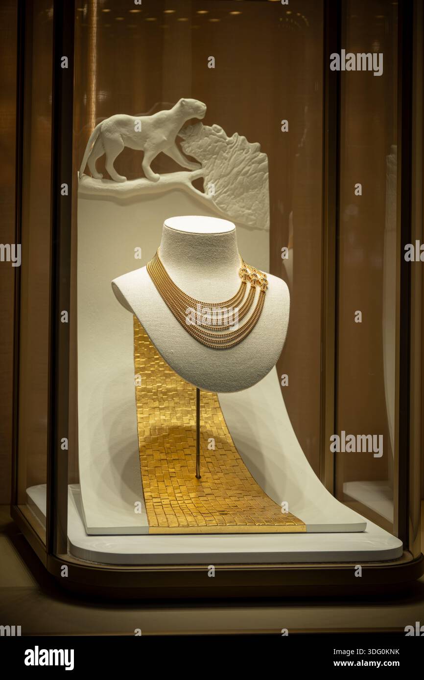 Milan, Italy - 2026, 13 Jan: Elegant Cartier FW25 gold necklace displayed on a sculpted stand with panther motif, highlighting luxury and refined craf Stock Photo