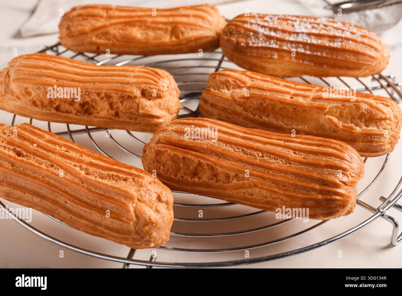 Grid with tasty eclairs on marble background Stock Photo