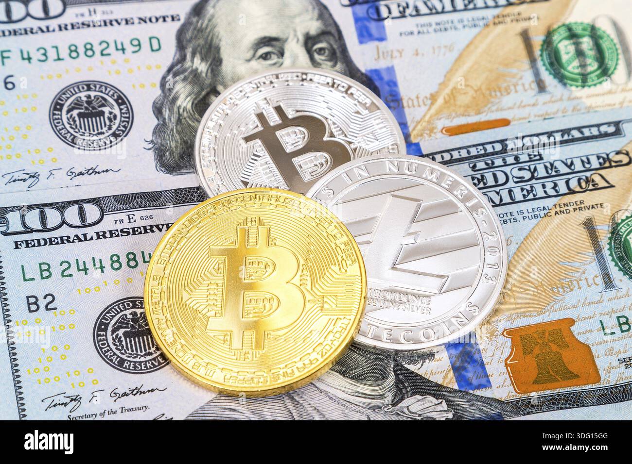 Coins of cryptocurrency lying over one hundred american dollar bills.  Business concept Stock Photo - Alamy