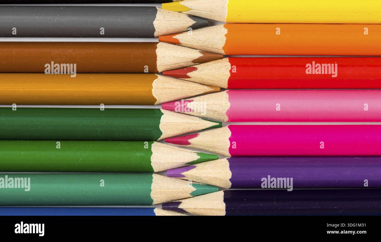 Color pencils on white table with tips in zigzag composition Stock Photo