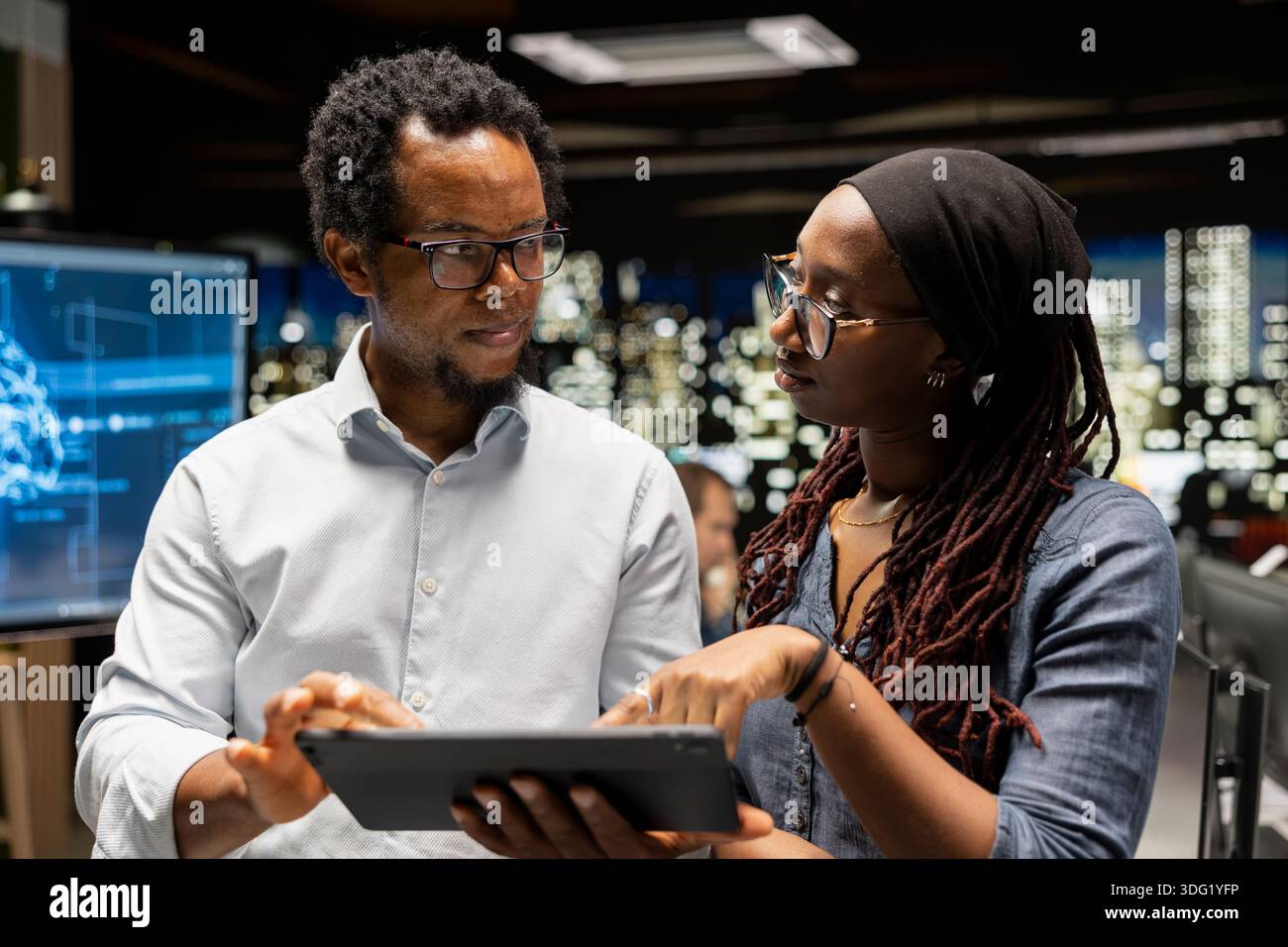 Team of programmers doing brainstorming, utilizing AI to optimize performance and forecast issues. Colleagues working together in tech startup office, training machine learning models Stock Photo