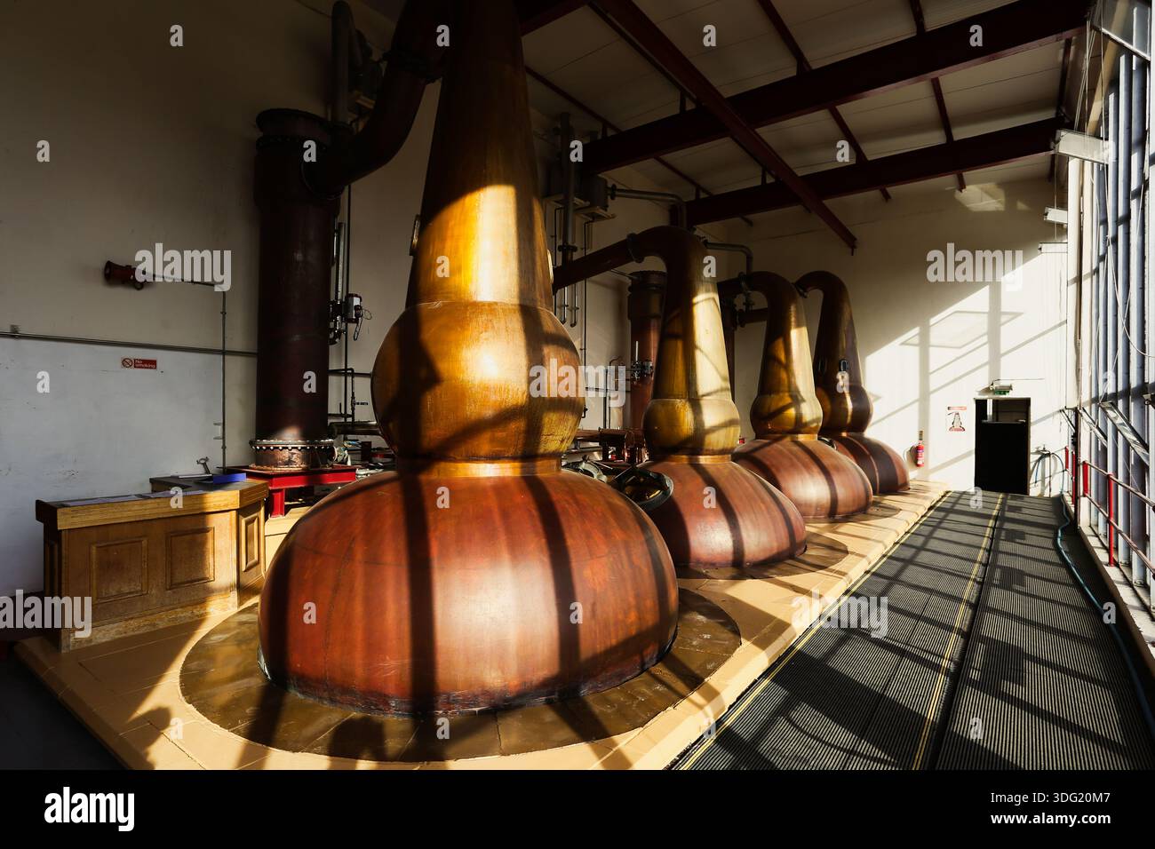Copper pot stills inside the distillery hall at The GlenDronach Distillery in Aberdeenshire, Scotland. Stock Photo