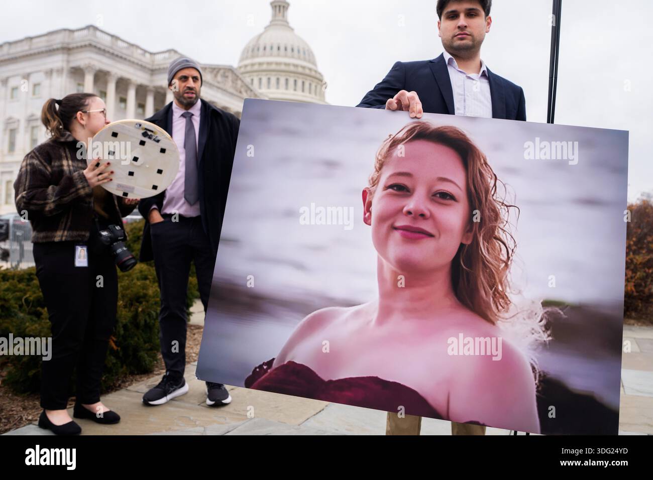 A photo of Renee Good is displayed as Democratic members of the House ...