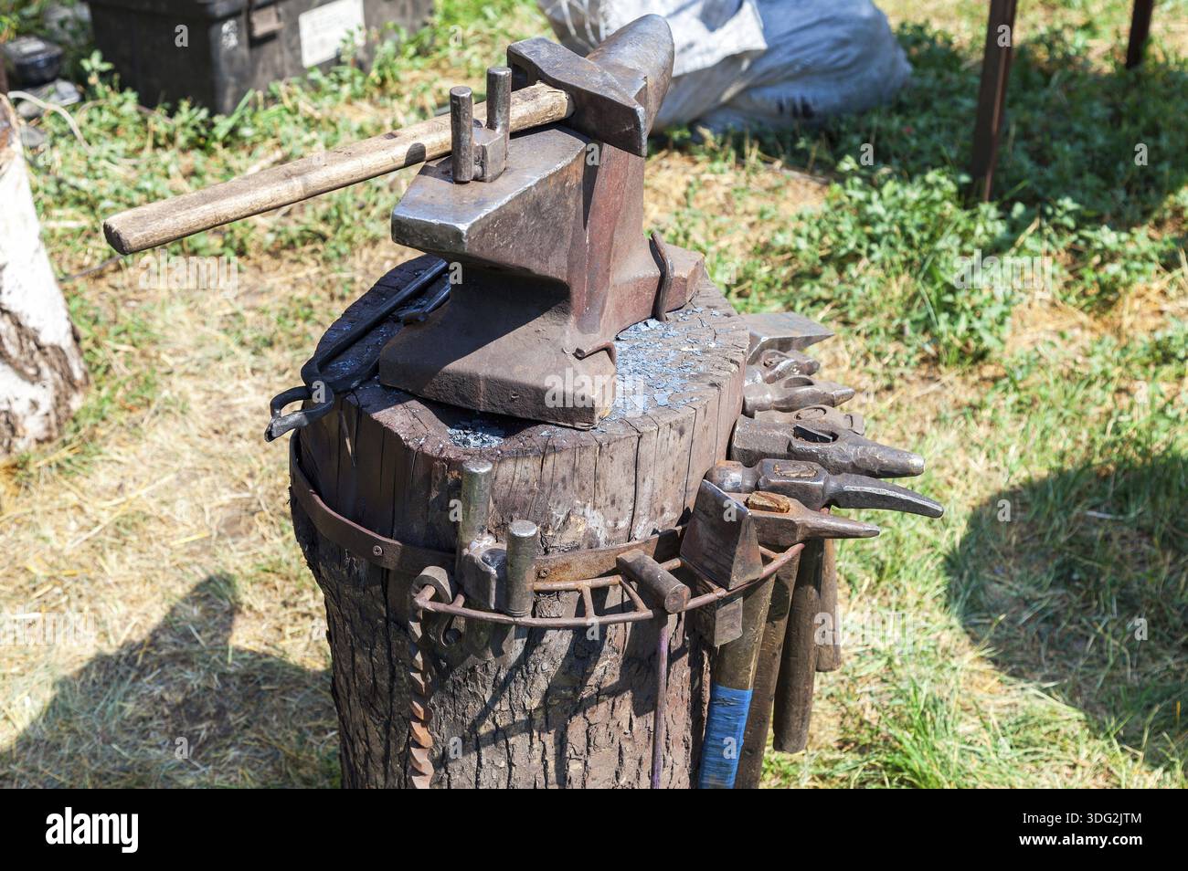Old anvil with blacksmith tools at the outdoors Stock Photo