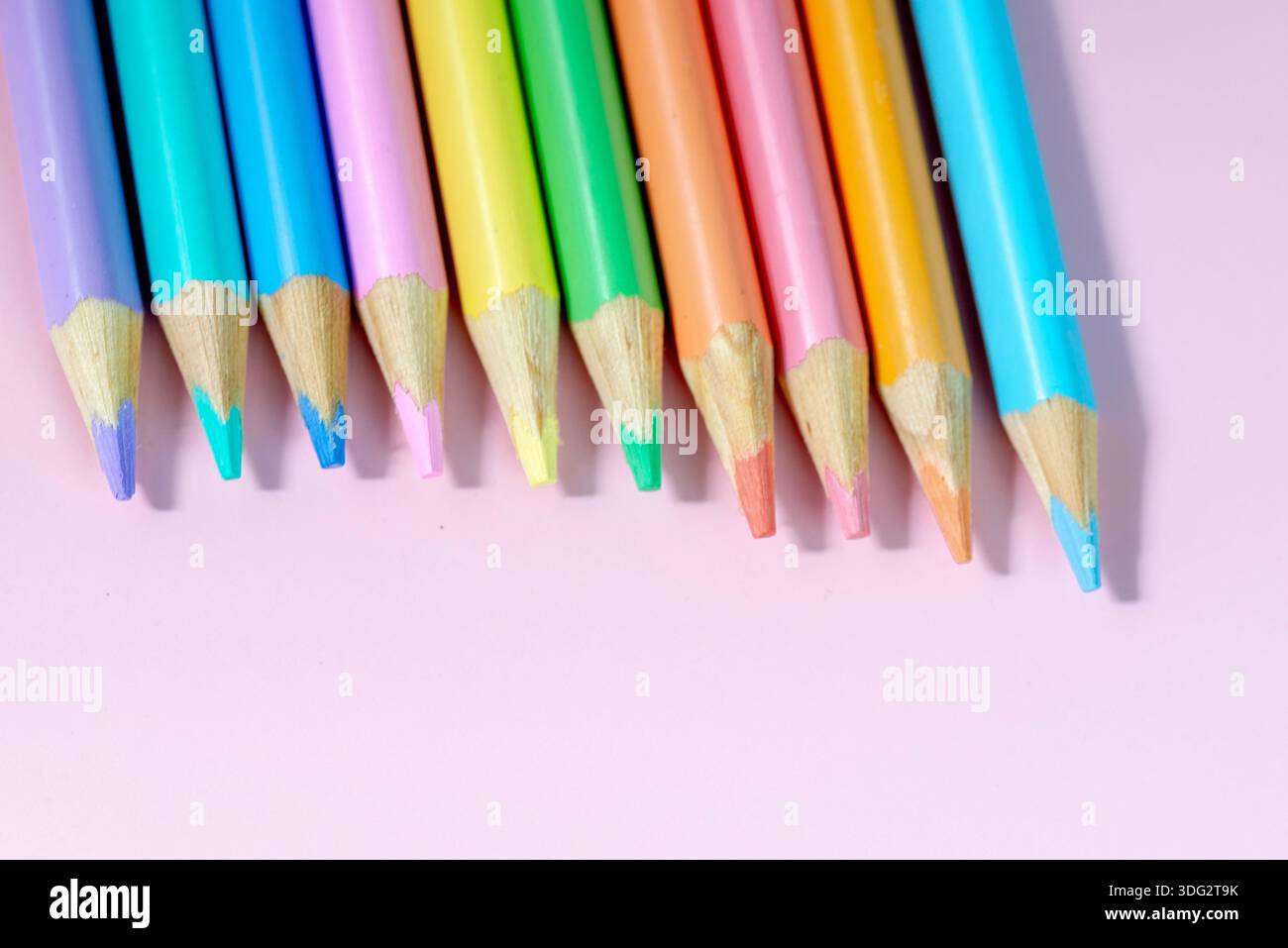Colored pencils on a pink background Stock Photo