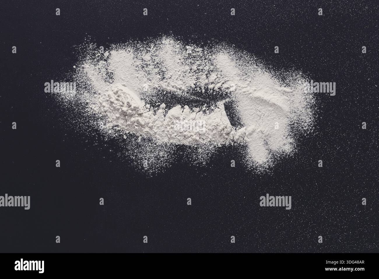 Sprinkled wheat flour splash spots on black background Stock Photo