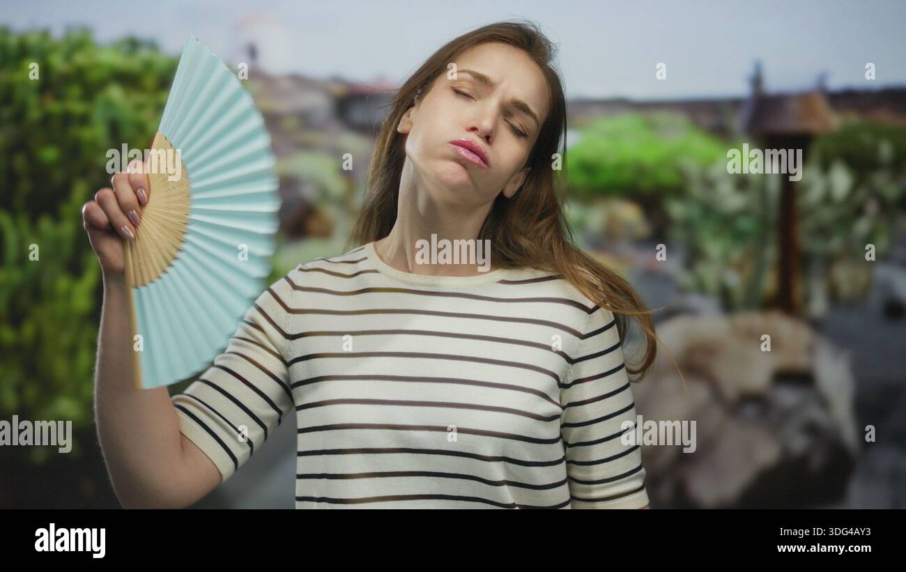 Woman fanning face handheld fan hi-res stock photography and images - Alamy