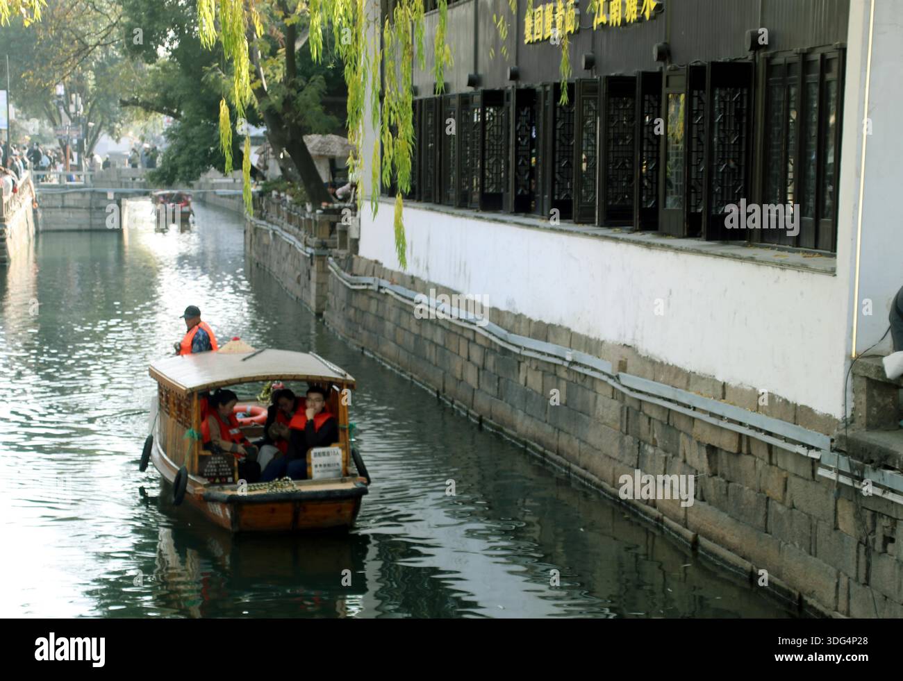 Tourists take traditional hand-rowed boat rides through the water ...