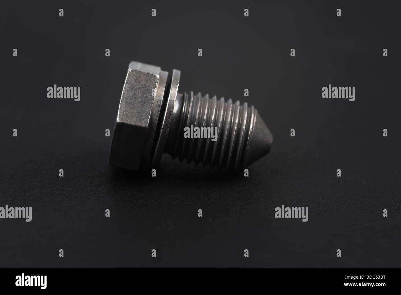 Metal bolt on dark background close up. Detail for design. Design elements. Macro. Stock Photo