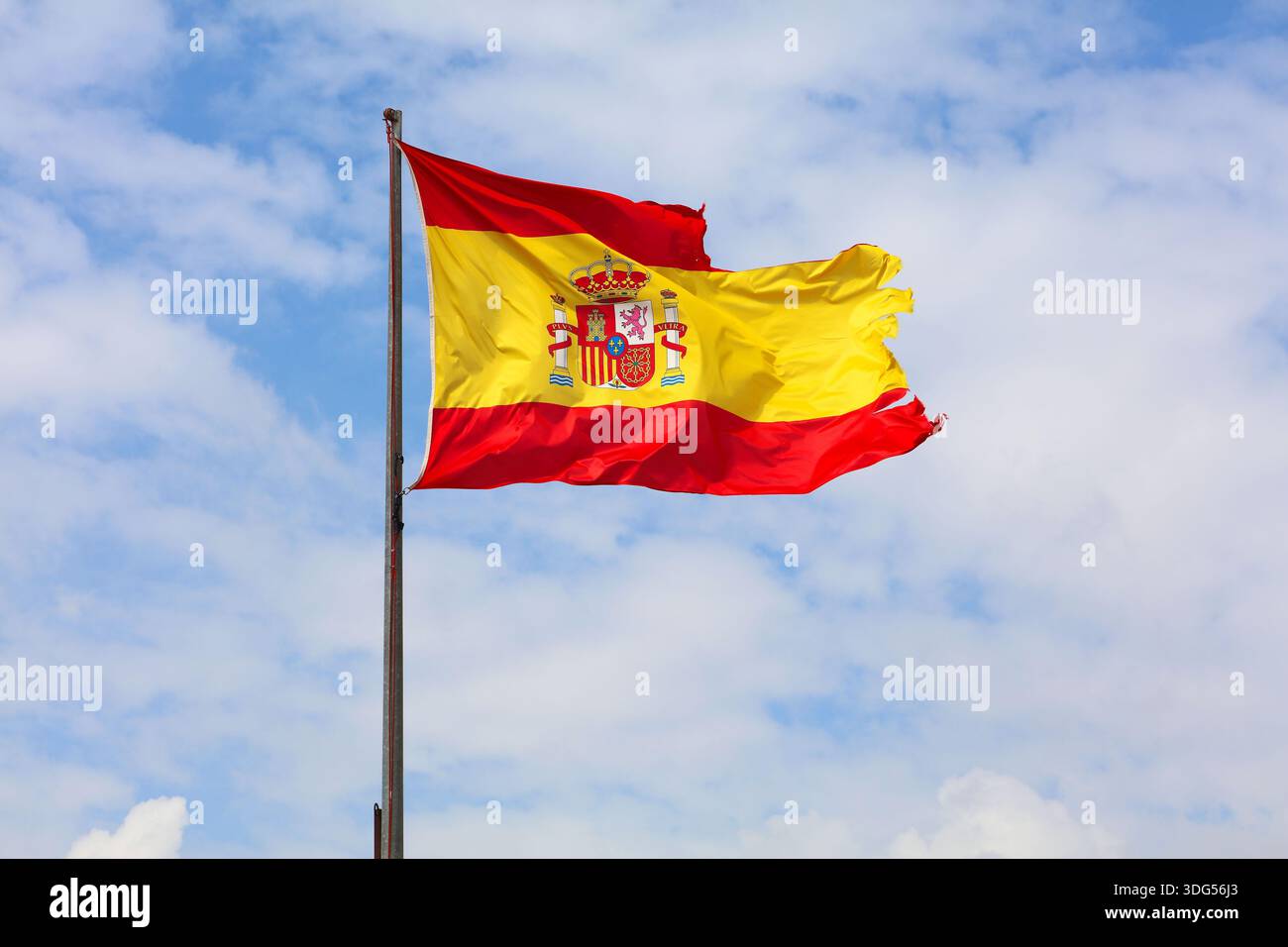 Flag of Spain. National flag torn and tattered by the wind. Stock Photo