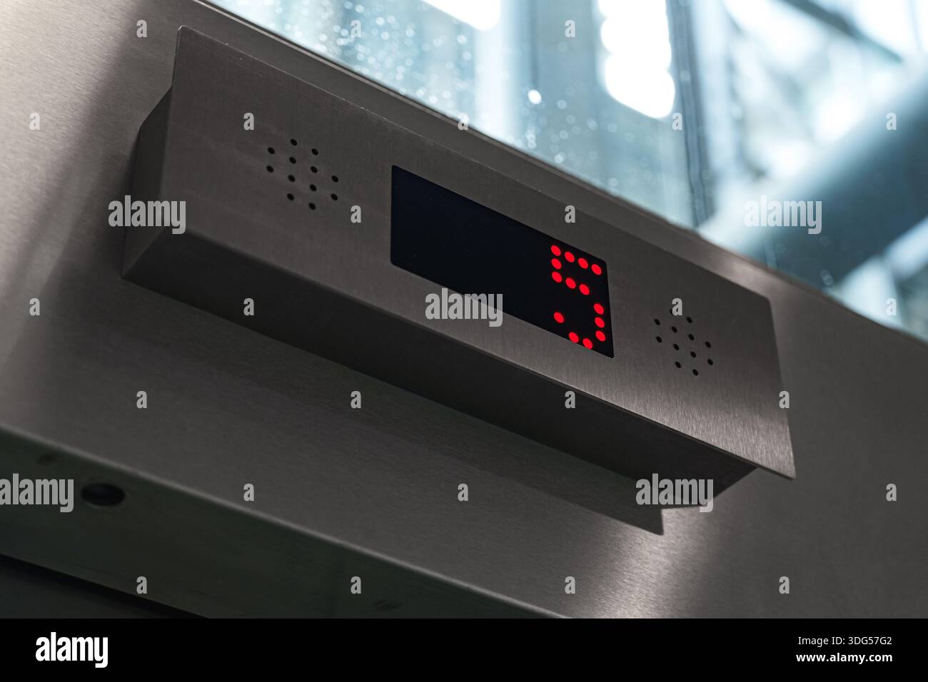 Modern elevator display showing floor number five in red digits Stock Photo