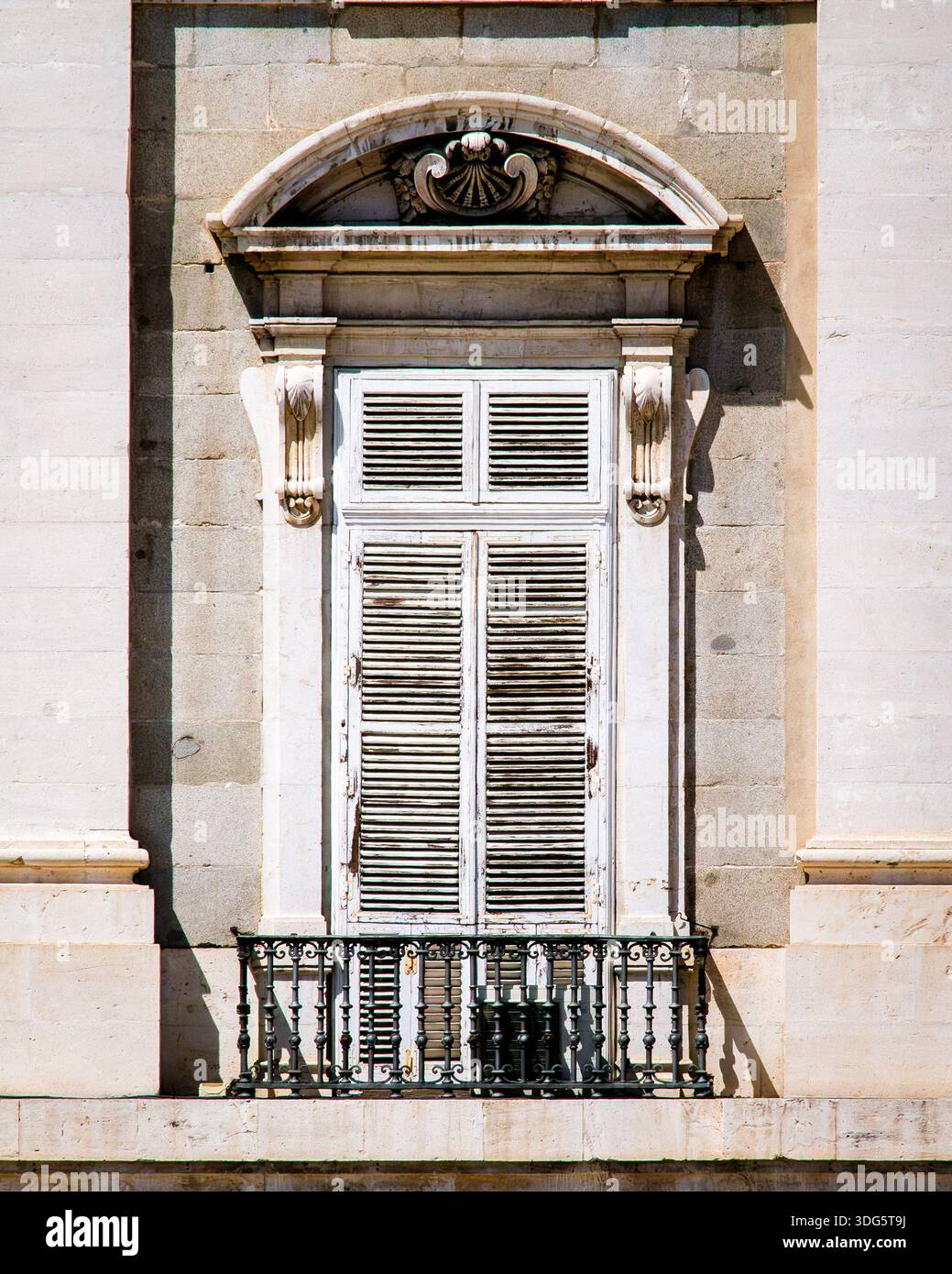 Old closed window with wooden shutters in bright colors Stock Photo