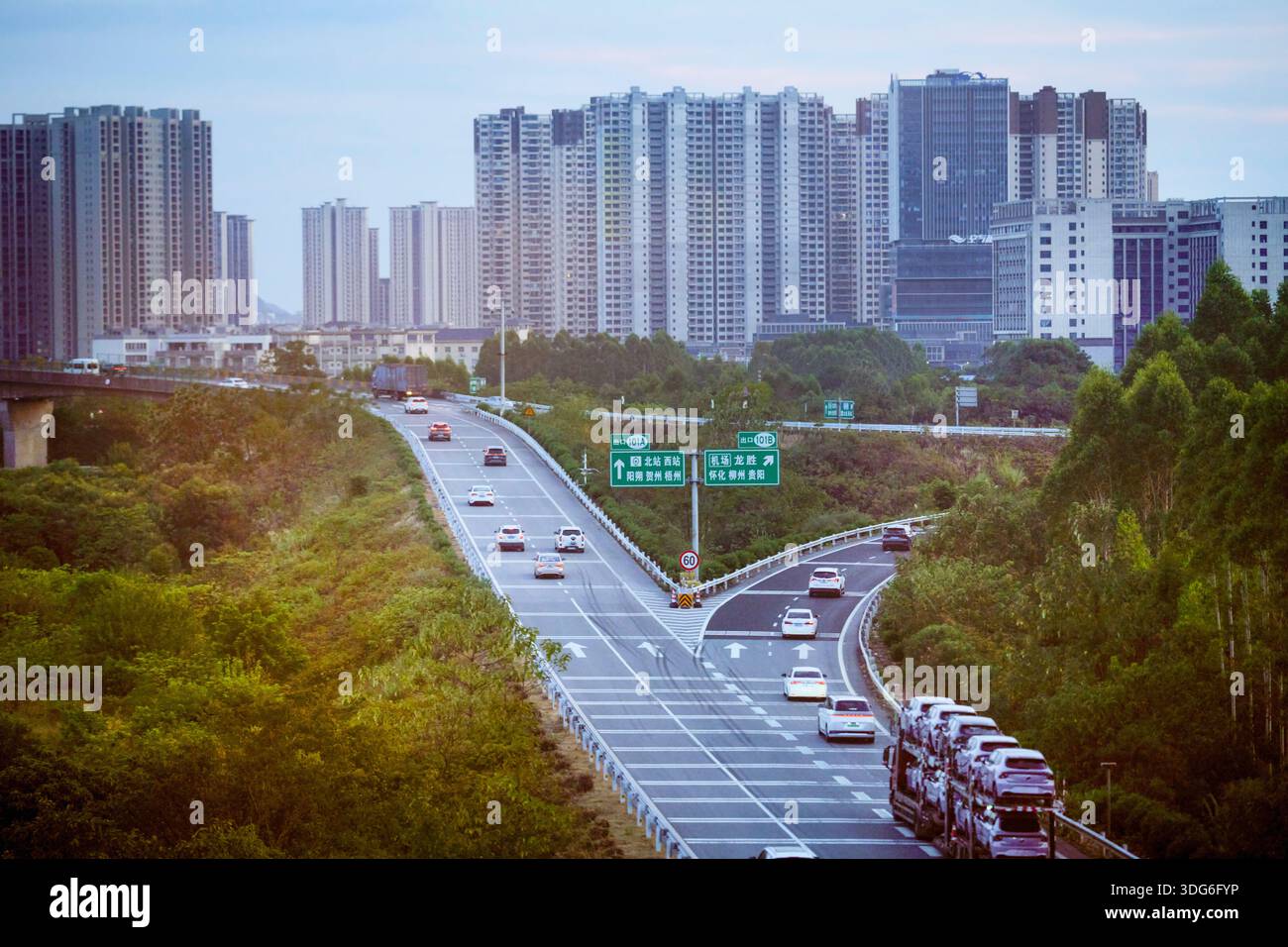 A cityscape with high-rise buildings and a highway filled with vehicles ...
