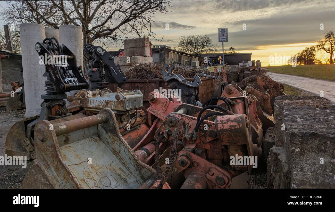 A cluttered scrapyard filled with piles of discarded metal and old machinery parts. - Smartphone Captured Stock Image